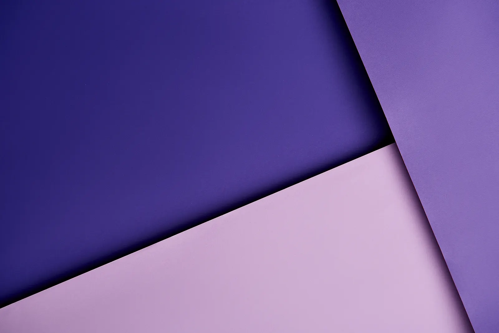 Overlapping sheets of purple and lilac paper forming a calm geometric composition